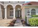 Elegant home with arched entry, brick walkway, and well-maintained landscaping at 1803 Glenbay Ct, Windermere, FL 34786