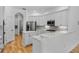 Bright kitchen featuring white cabinets, stainless steel appliances, and a large island with quartz countertops at 1803 Glenbay Ct, Windermere, FL 34786