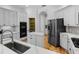 Spacious kitchen featuring stainless steel appliances, white cabinetry, and an island with quartz countertops at 1803 Glenbay Ct, Windermere, FL 34786