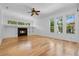 Spacious living room featuring a fireplace and large windows for natural light at 1803 Glenbay Ct, Windermere, FL 34786