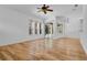Light-filled living room with hardwood floors, fan, and sliding glass doors leading to the outside at 1803 Glenbay Ct, Windermere, FL 34786