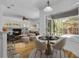 An open-concept living room flowing into a dining area with views of the pool and outdoor area at 1803 Glenbay Ct, Windermere, FL 34786