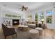 Living room with fireplace, comfortable seating, and lots of natural light at 1803 Glenbay Ct, Windermere, FL 34786