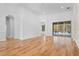 Open living room boasting hardwood floors, archways, and seamless access to the outdoors through large sliding glass doors at 1803 Glenbay Ct, Windermere, FL 34786