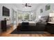 Main bedroom with hardwood floors, ceiling fan, and sliding glass door to the pool area at 1803 Glenbay Ct, Windermere, FL 34786