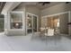 Covered patio seating area with ceiling fan overlooks the Primary bedroom through sliding glass doors and picture window at 1803 Glenbay Ct, Windermere, FL 34786