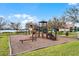 Playground with swings, slides, and climbing structures with a lake view, surrounded by landscaping at 1803 Glenbay Ct, Windermere, FL 34786
