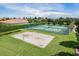 Overhead view of tennis and sand volleyball courts surrounded by lush landscaping and community homes at 1803 Glenbay Ct, Windermere, FL 34786