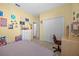 This bedroom features carpet, a bed, a desk, and a double closet at 235 Largovista Dr, Oakland, FL 34787