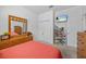 This cozy bedroom features carpet, a dresser with a large mirror and a TV at 235 Largovista Dr, Oakland, FL 34787