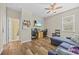 The bedroom features a wood floor, TV, ceiling fan, and a blue sofa at 235 Largovista Dr, Oakland, FL 34787