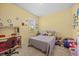 This bedroom features a bed, carpet, a desk, and a window at 235 Largovista Dr, Oakland, FL 34787