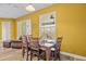 Bright dining area with wood table, chairs, and view to outdoor patio through sliding glass door at 235 Largovista Dr, Oakland, FL 34787