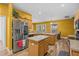 Bright kitchen featuring an island, stainless steel appliances, and wood cabinets at 235 Largovista Dr, Oakland, FL 34787
