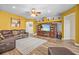 Cozy living room featuring entertainment center, leather sofa, and wood flooring at 235 Largovista Dr, Oakland, FL 34787