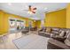 Open living room with leather furniture, wood floors, and bright natural light at 235 Largovista Dr, Oakland, FL 34787