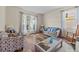 Inviting living room with large windows, wood floors, and cozy seating arrangement at 235 Largovista Dr, Oakland, FL 34787