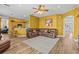 Spacious living room featuring a leather sectional, wood floors, and bright yellow walls at 235 Largovista Dr, Oakland, FL 34787