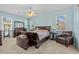 Serene main bedroom with cool blue walls, a ceiling fan, and elegant furnishings at 235 Largovista Dr, Oakland, FL 34787