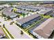 Community aerial view featuring screened-in patios, landscaping, and nearby pond surrounded by houses at 2432 Tangier Dr, Kissimmee, FL 34747