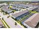 Aerial view of a community with lakes, and houses, featuring screened-in patios, landscaping, and on-site parking at 2432 Tangier Dr, Kissimmee, FL 34747
