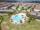 An aerial view of a community pool and amenity center, surrounded by homes and landscaping at 2432 Tangier Dr, Kissimmee, FL 34747