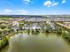 An aerial view of a Primary-planned community showcasing a large lake and recreation center at 2432 Tangier Dr, Kissimmee, FL 34747