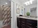 Bright bathroom features a double sink vanity with granite countertop and a shower with a decorative curtain at 2432 Tangier Dr, Kissimmee, FL 34747