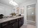 Bathroom features a granite countertop vanity with dual sinks and a glass-enclosed shower at 2432 Tangier Dr, Kissimmee, FL 34747