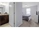 Bedroom and bathroom featuring a queen bed, a tiled floor bathroom, and a white cabinet at 2432 Tangier Dr, Kissimmee, FL 34747