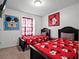 bedroom with twin beds, themed bedding, and colorful Disney wall art at 2432 Tangier Dr, Kissimmee, FL 34747