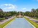 Beautiful community entrance with a reflective water feature, clock tower and manicured landscaping at 2432 Tangier Dr, Kissimmee, FL 34747