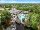 Aerial view of the community center, pool, and lake with lush landscaping at 2432 Tangier Dr, Kissimmee, FL 34747