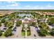 Aerial view of a community pool and clubhouse with a lake and ample parking at 2432 Tangier Dr, Kissimmee, FL 34747