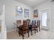 Dining room features a rustic table with six chairs and beach-themed wall art at 2432 Tangier Dr, Kissimmee, FL 34747