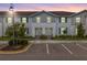 Charming townhome with neat landscaping, gray siding, and blue shutters at 2432 Tangier Dr, Kissimmee, FL 34747