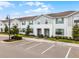 Charming townhome exterior with light blue siding and shutters, complemented by a manicured lawn at 2432 Tangier Dr, Kissimmee, FL 34747