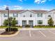 Charming townhome exterior featuring light blue siding, shutters, and well-kept landscaping at 2432 Tangier Dr, Kissimmee, FL 34747