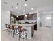 Modern kitchen featuring a large island with seating, pendant lights, and stainless steel appliances at 2432 Tangier Dr, Kissimmee, FL 34747