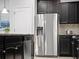Modern kitchen with stainless steel appliances, dark wood cabinets, and granite countertops at 2432 Tangier Dr, Kissimmee, FL 34747