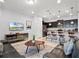 Open concept living area with modern decor and kitchen featuring bar stool seating at 2432 Tangier Dr, Kissimmee, FL 34747