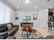 Bright living room featuring a leather sofa, modern media center, and stylish decor at 2432 Tangier Dr, Kissimmee, FL 34747