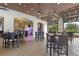 Spacious lounge area with high-top tables, open garage doors, and view to arcade with games at 2432 Tangier Dr, Kissimmee, FL 34747