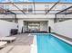 Beautiful pool area with lounge chairs, lighting, and well-maintained landscaping at 2432 Tangier Dr, Kissimmee, FL 34747
