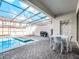 Outdoor pool and lounge area with outdoor kitchen and dining amenities at 2432 Tangier Dr, Kissimmee, FL 34747