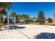 Beach volleyball court surrounded by lush trees and clear blue skies for a fun and active lifestyle at 2432 Tangier Dr, Kissimmee, FL 34747
