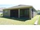 Back exterior of home with screened in porch at 245 Brunswick Dr, Davenport, FL 33837