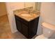 Bathroom with granite countertops, undermount sink, and dark wood cabinets at 245 Brunswick Dr, Davenport, FL 33837