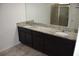 Bathroom featuring granite double vanity with modern fixtures and a glass-enclosed shower at 245 Brunswick Dr, Davenport, FL 33837