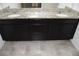 Bathroom vanity with double sinks, granite countertops, and dark cabinets at 245 Brunswick Dr, Davenport, FL 33837